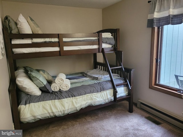 bedroom featuring baseboard heating and carpet