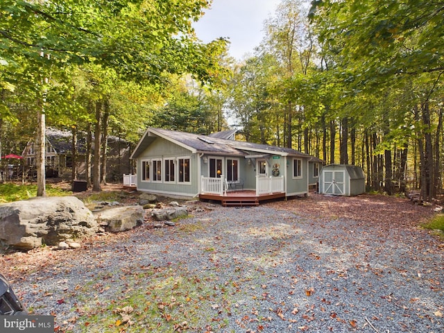 view of front facade featuring a deck and a storage shed