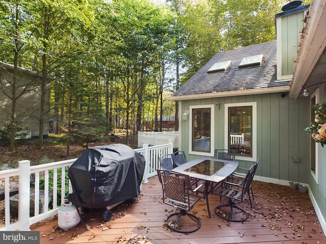 wooden deck featuring a grill