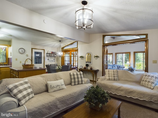 living room with french doors, sink, vaulted ceiling with beams, a textured ceiling, and a notable chandelier