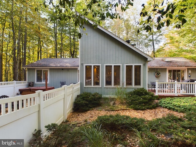 back of house featuring a wooden deck