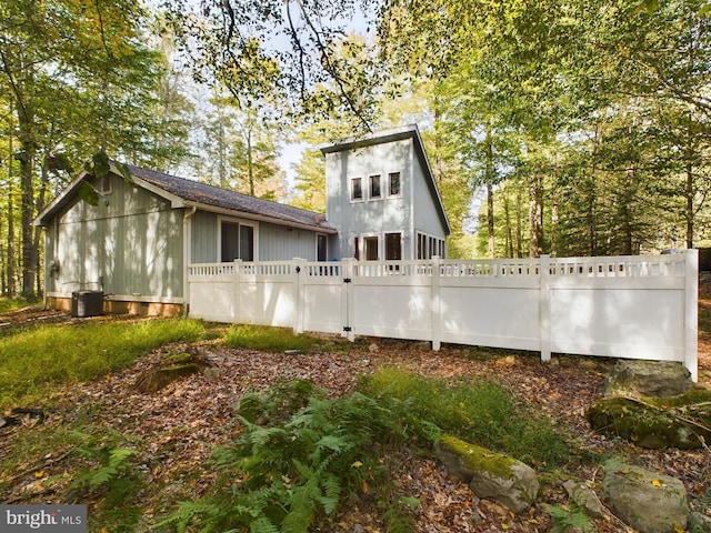 rear view of property with central AC unit