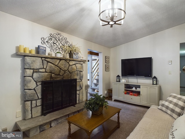 carpeted living room with a notable chandelier, a stone fireplace, and a textured ceiling