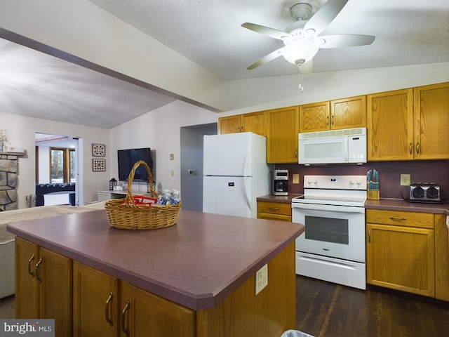 kitchen featuring ceiling fan, dark hardwood / wood-style flooring, lofted ceiling, white appliances, and a kitchen island