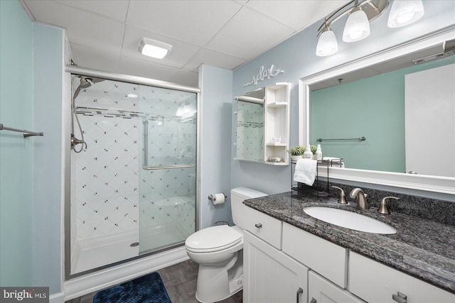 110 81st St Unit G03, Ocean City, MD 21842 - bathroom featuring a shower stall, toilet, vanity, and a drop ceiling