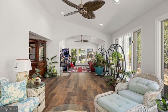 living room featuring vaulted ceiling, dark hardwood / wood-style flooring, and a healthy amount of sunlight