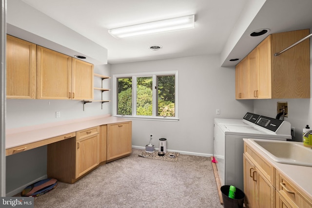 laundry area with light carpet, cabinets, sink, and independent washer and dryer