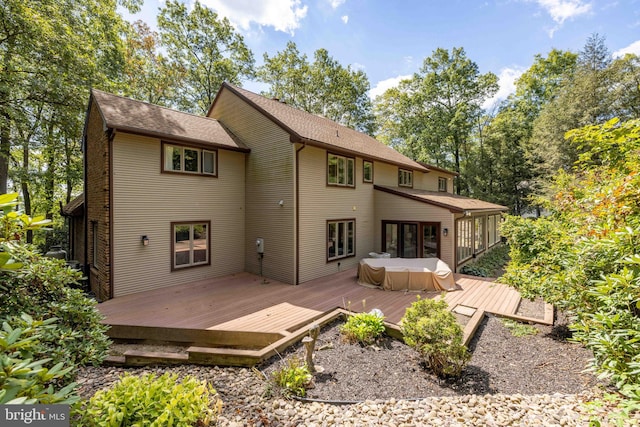 rear view of house featuring a wooden deck