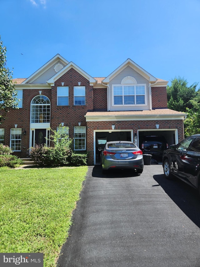 view of front of house featuring a front yard and a garage