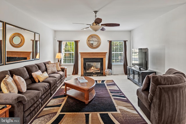 carpeted living room with plenty of natural light and ceiling fan