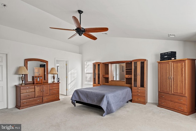 bedroom featuring lofted ceiling, light colored carpet, and ceiling fan