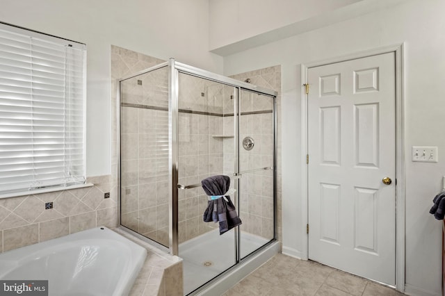 bathroom with independent shower and bath and tile patterned flooring