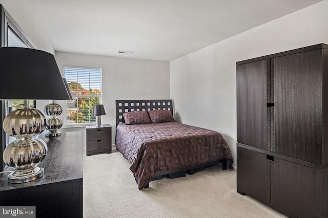 bedroom with light colored carpet