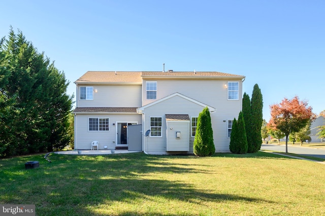 back of house featuring a yard and a patio