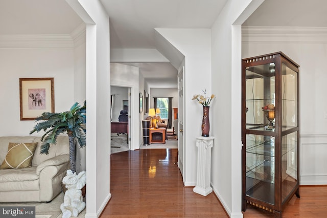 hallway with crown molding and hardwood / wood-style flooring