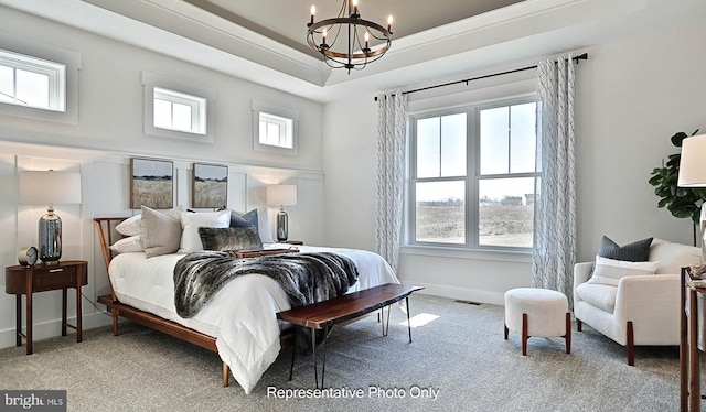 bedroom featuring an inviting chandelier and carpet