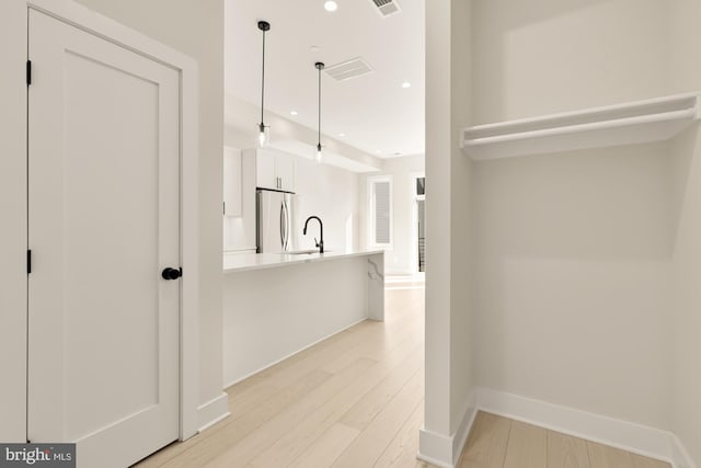 interior space with sink and light wood-type flooring