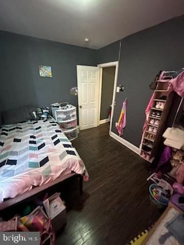 bedroom featuring dark hardwood / wood-style flooring