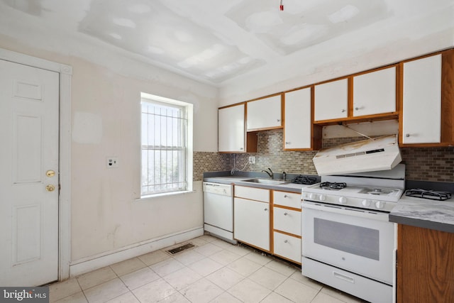 kitchen featuring sink, tasteful backsplash, white appliances, and white cabinetry