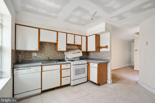 kitchen with white cabinets, white appliances, tasteful backsplash, and sink