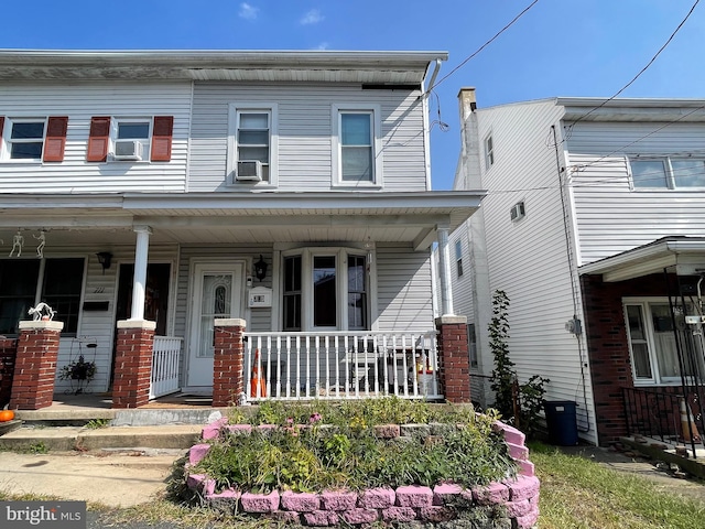 view of front facade featuring cooling unit and covered porch