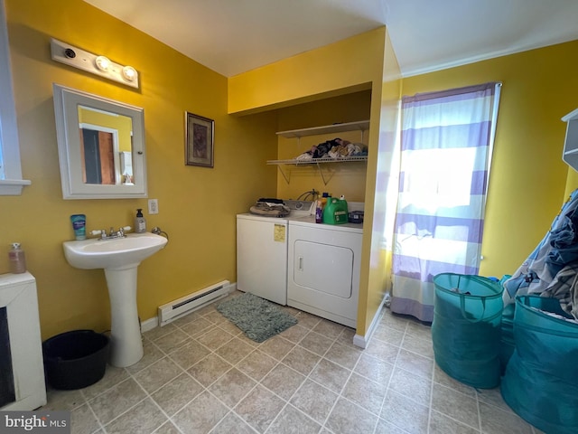 bathroom featuring sink, baseboard heating, and washer and dryer