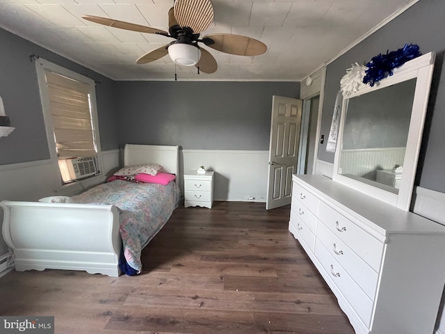 bedroom featuring ceiling fan, ornamental molding, cooling unit, and dark hardwood / wood-style flooring