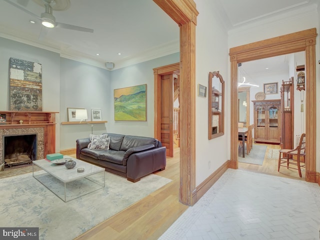 living room with ceiling fan, light hardwood / wood-style floors, and ornamental molding