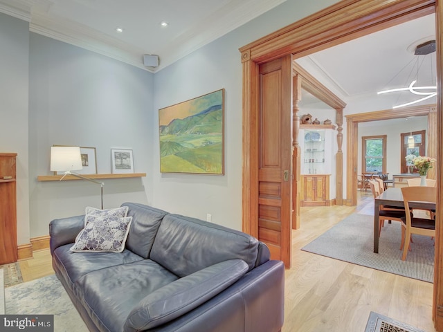 living room featuring light hardwood / wood-style flooring and ornamental molding