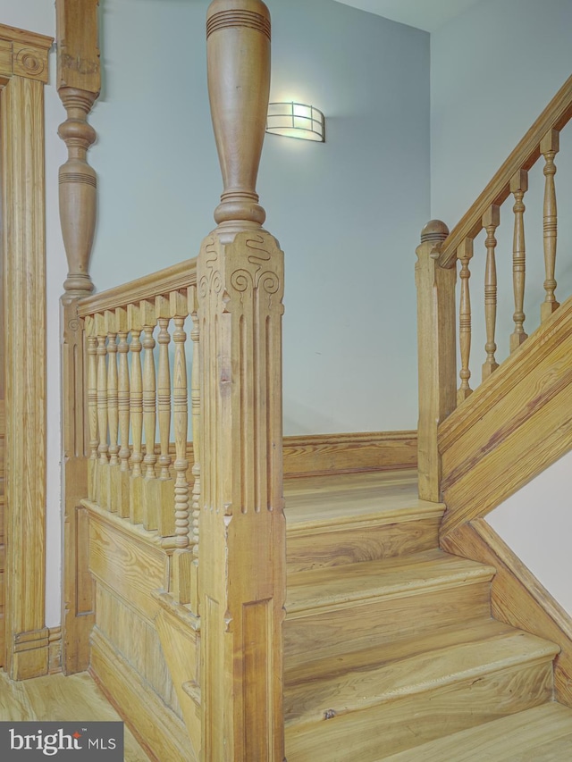 stairway featuring wood-type flooring