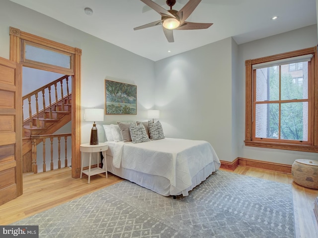 bedroom with wood-type flooring and ceiling fan