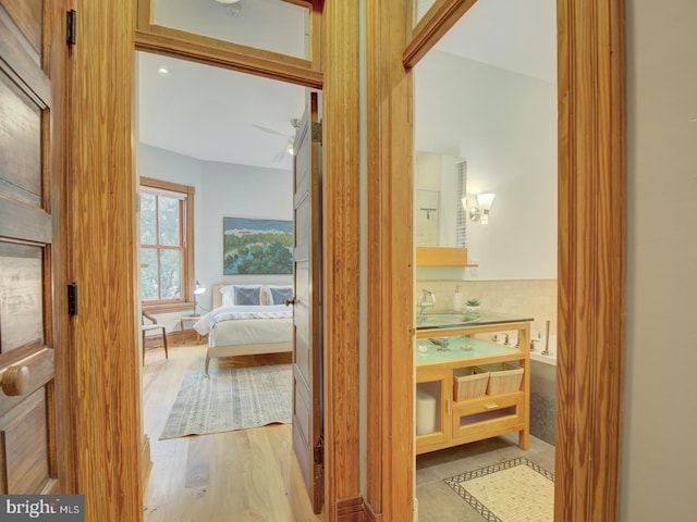 hall featuring light hardwood / wood-style floors and sink