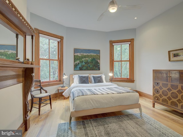 bedroom with ceiling fan and light hardwood / wood-style flooring