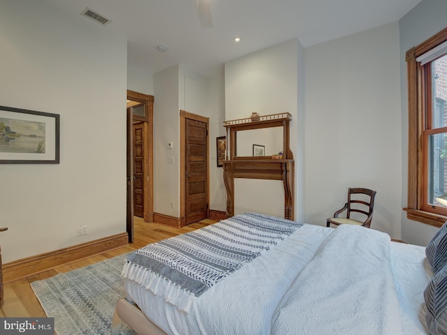 bedroom with ceiling fan and light hardwood / wood-style flooring