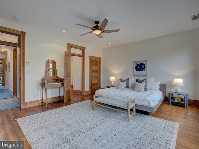 bedroom with ceiling fan and hardwood / wood-style floors