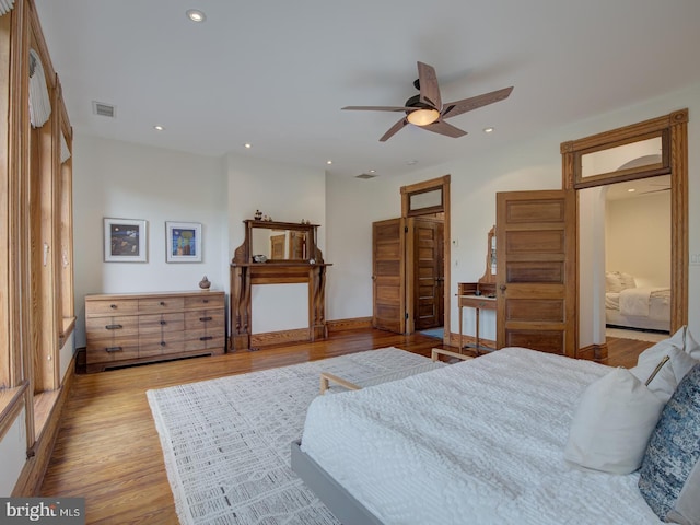 bedroom with ceiling fan and light hardwood / wood-style flooring