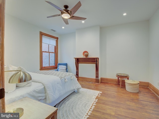 bedroom featuring ceiling fan and light hardwood / wood-style flooring