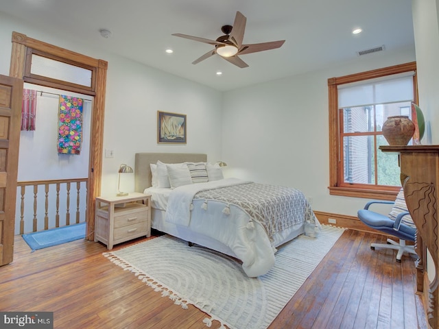 bedroom with ceiling fan and hardwood / wood-style floors