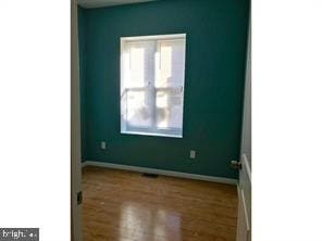 unfurnished room with hardwood / wood-style floors