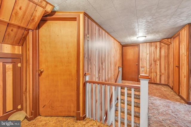 bonus room featuring wood walls