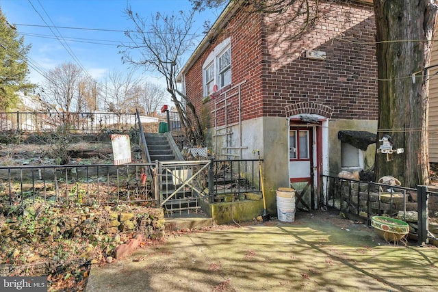 32 S Jackson St, Pottsville, PA 17901 - view of side of property with stairs, fence, and brick siding