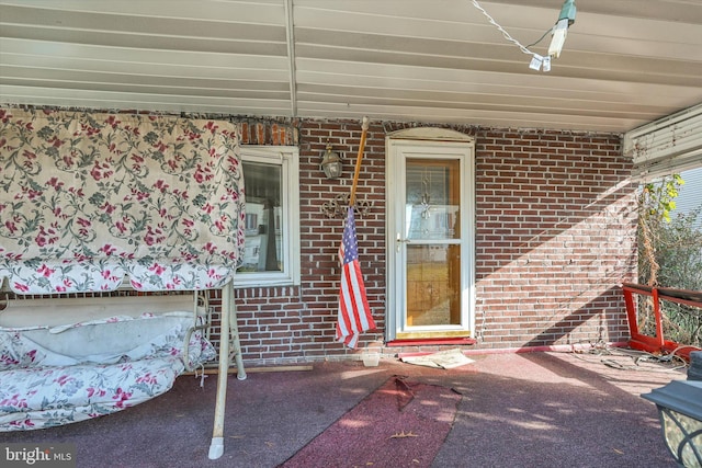 entrance to property featuring a patio