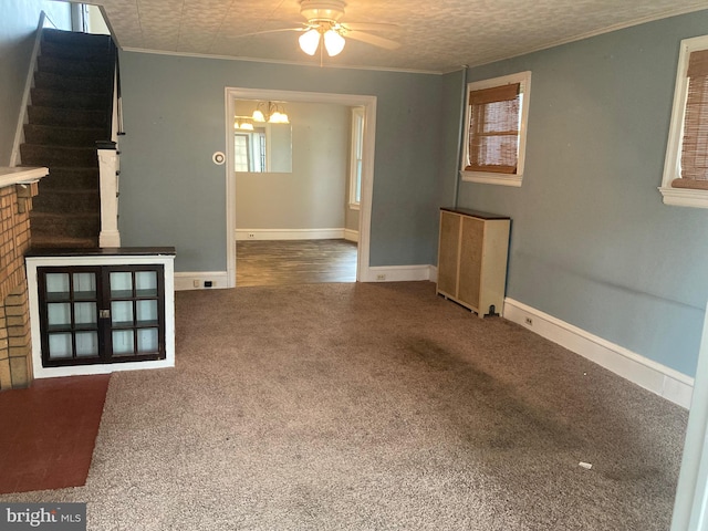 unfurnished living room featuring radiator, plenty of natural light, and carpet