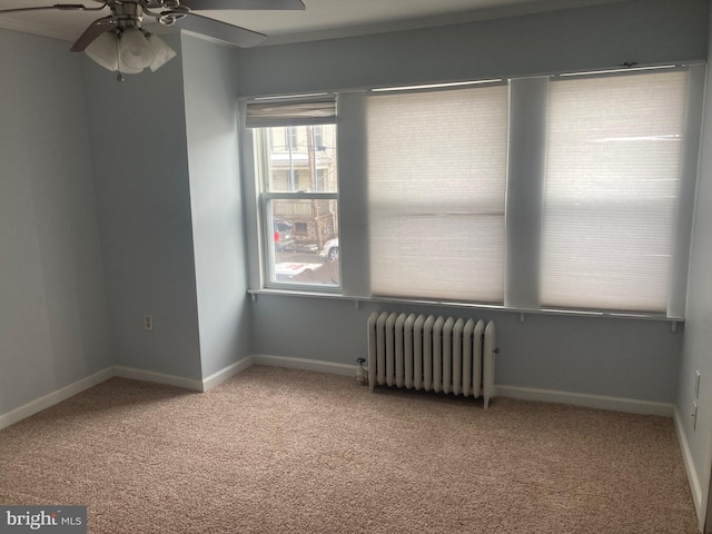 unfurnished room featuring light carpet, radiator, and ceiling fan