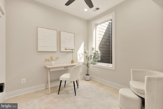 office area with light hardwood / wood-style flooring and ceiling fan