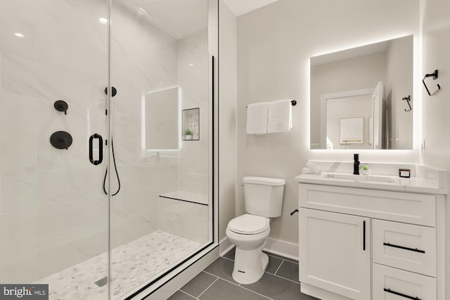 bathroom with walk in shower, vanity, toilet, and tile patterned floors