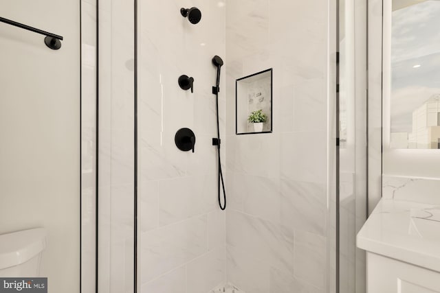 interior details featuring toilet and a shower with door