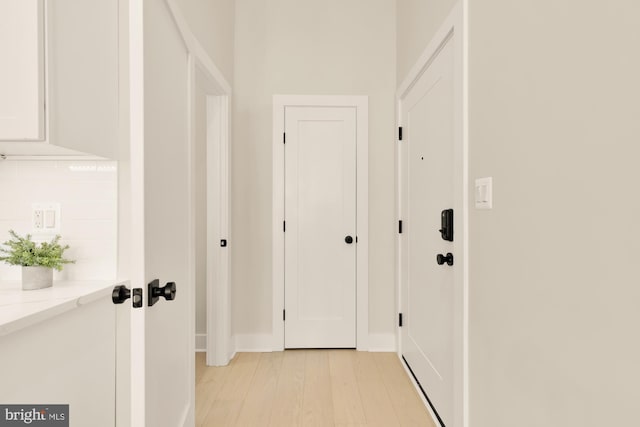 corridor with light hardwood / wood-style flooring