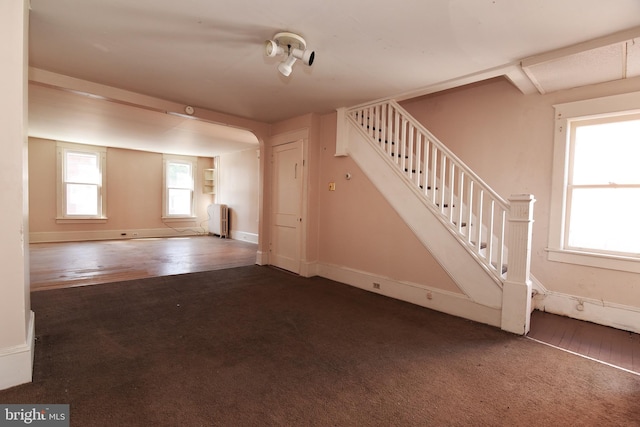 interior space with dark hardwood / wood-style floors and radiator heating unit