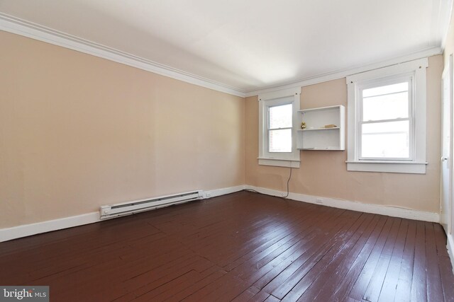 empty room featuring crown molding, dark hardwood / wood-style floors, and a baseboard heating unit